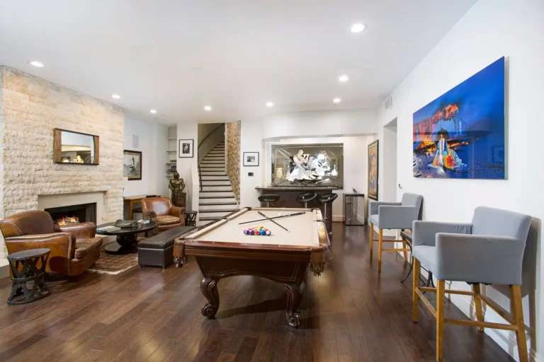 Legacy Healings luxury drug and alcohol rehab in Los Angeles, California, with game room equipped with a billards table, fireplace and seating.