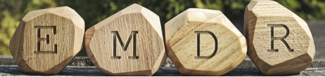 Wooden sculptures with the letters EMDR carved into them