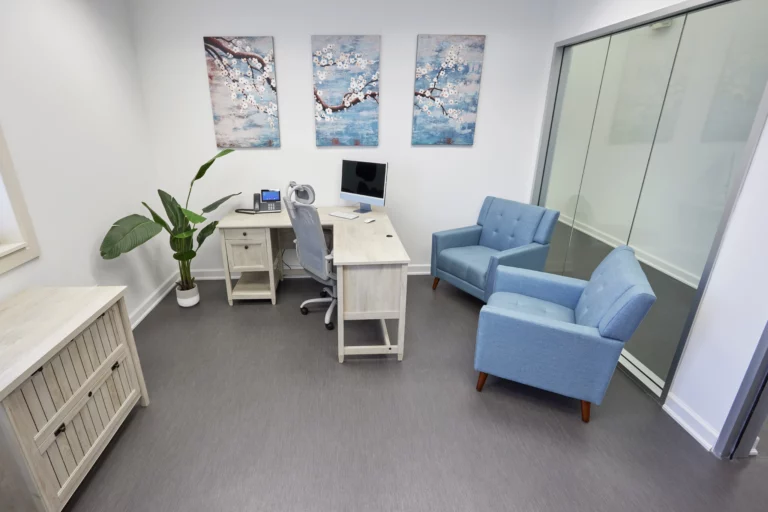 Patient meeting room with calming, light blue aesthetic that has two chairs facing a desk at Legacy Healing Center’s Cincinnati drug and alcohol rehab