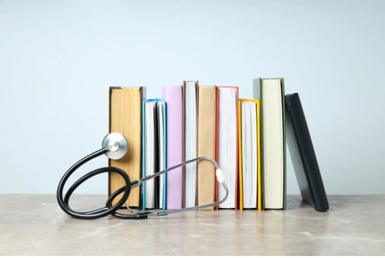 Research books lined up with stethoscope propped up in front