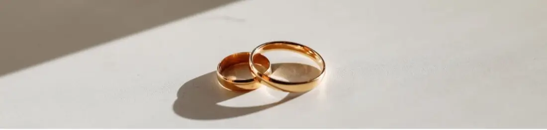 Two wedding bands on a white surface