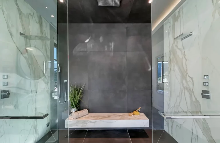 Luxurious, modern shower with rainfall spout and marble bench