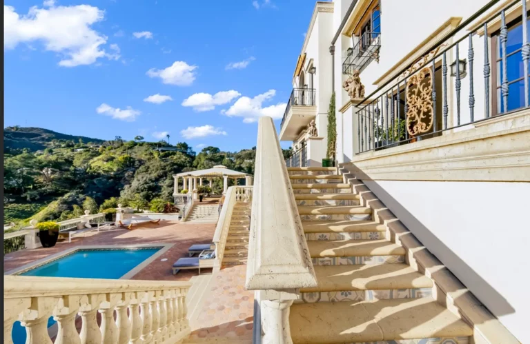 Outdoor staircases in an Italian style that run from the large, luxurious pool up to the main building at Legacy's Los Angeles drug and alcohol rehab