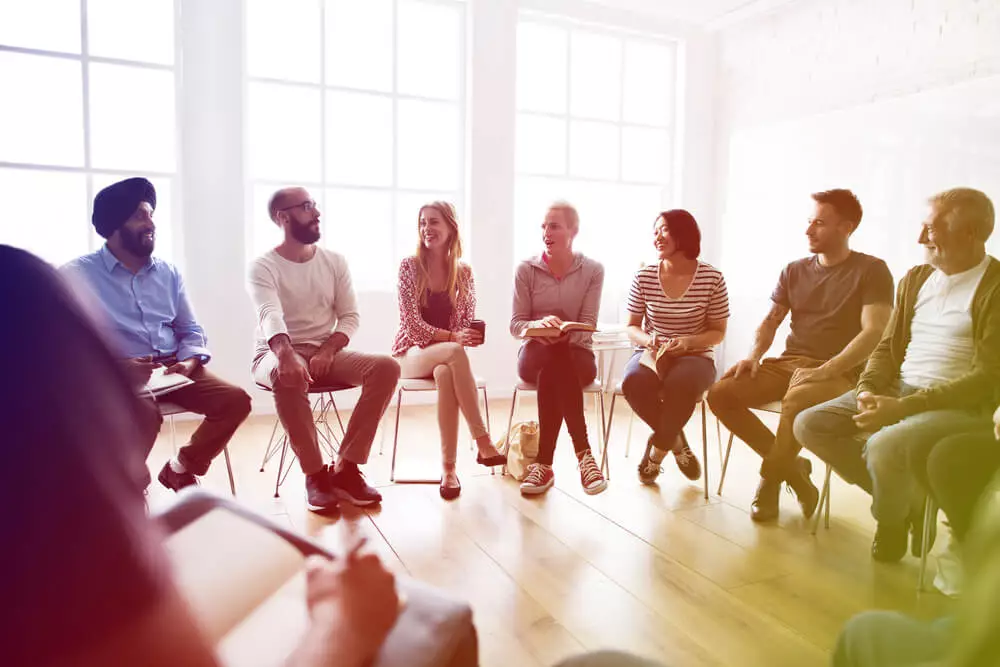 People in rehab group therapy session at addiction treatment center