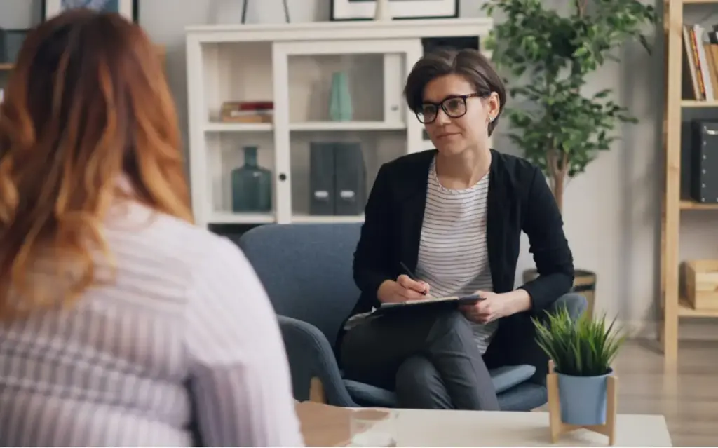 Therapist meeting one-on-one with a client in a comfortable, modern office at a luxury addiction treatment center in Los Angeles, California, focused on personalized rehab and mental health support.